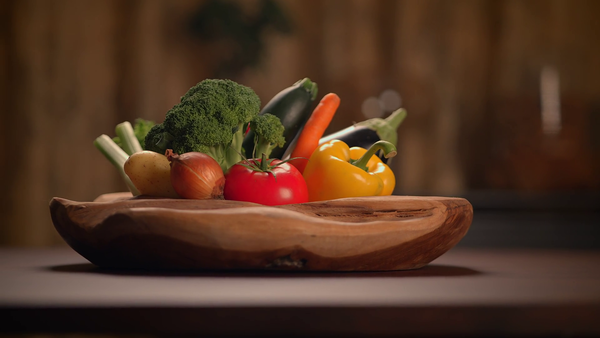 رنگ برنگی سبزیوں اور پھلوں کی پلیٹ، لکڑی کی میز پر پرسکون انداز میں رکھی ہوئی